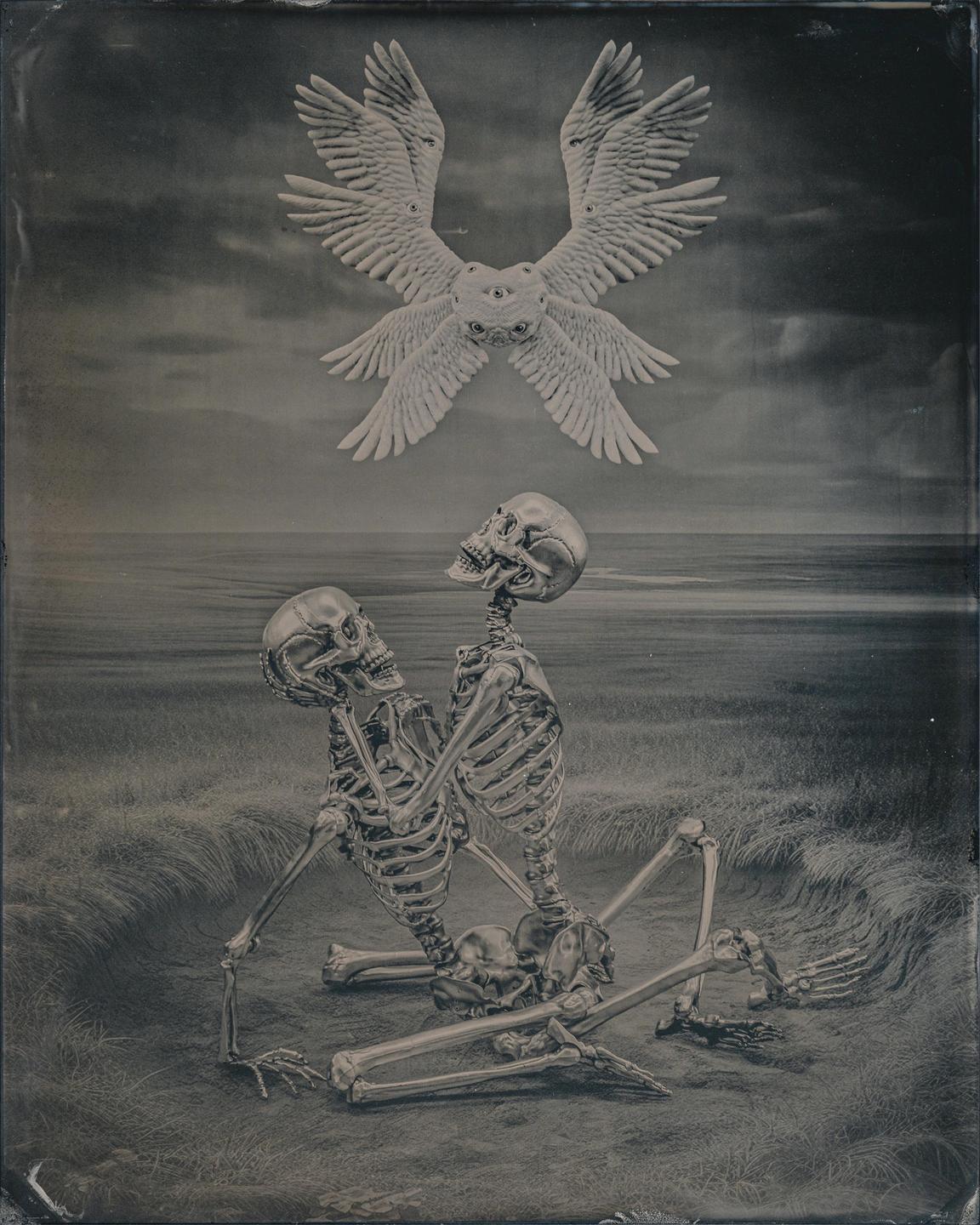 Two skeletons sit on the ground looking up at a winged, multi-eyed creature floating in the sky above a body of water.