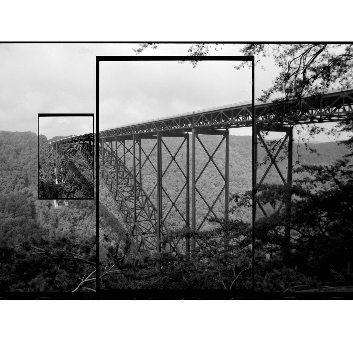 A long bridge spans a valley covered in trees under a cloudy sky.