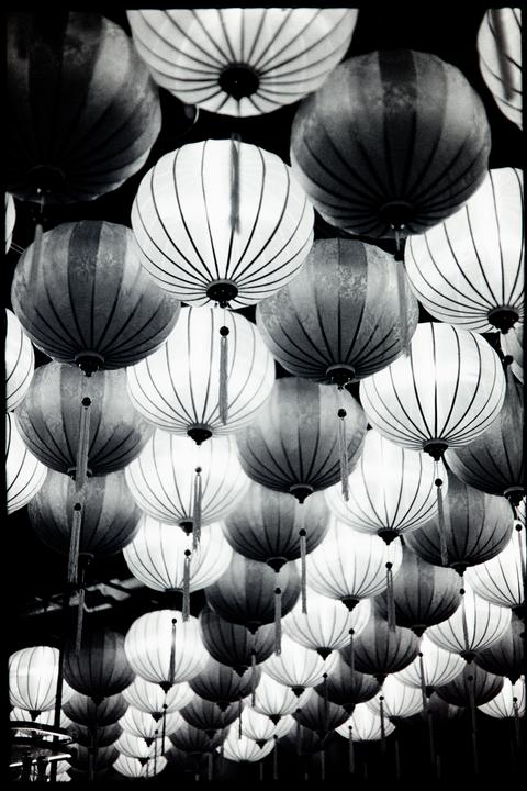 Many round lanterns hang from above, some with tassels.