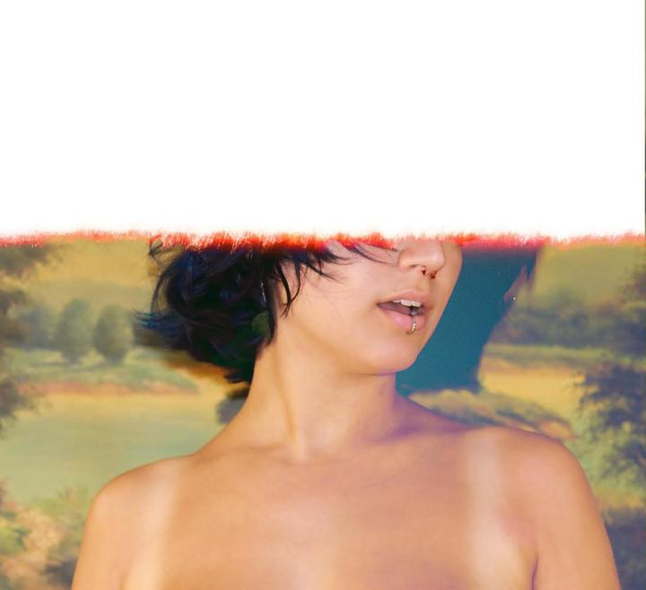 A woman with short dark hair and a nose piercing is shown from the shoulders up, with a painted landscape behind her.