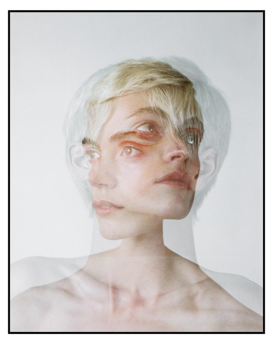 A woman with short blonde hair is shown in a double exposure with multiple eyes and mouths.