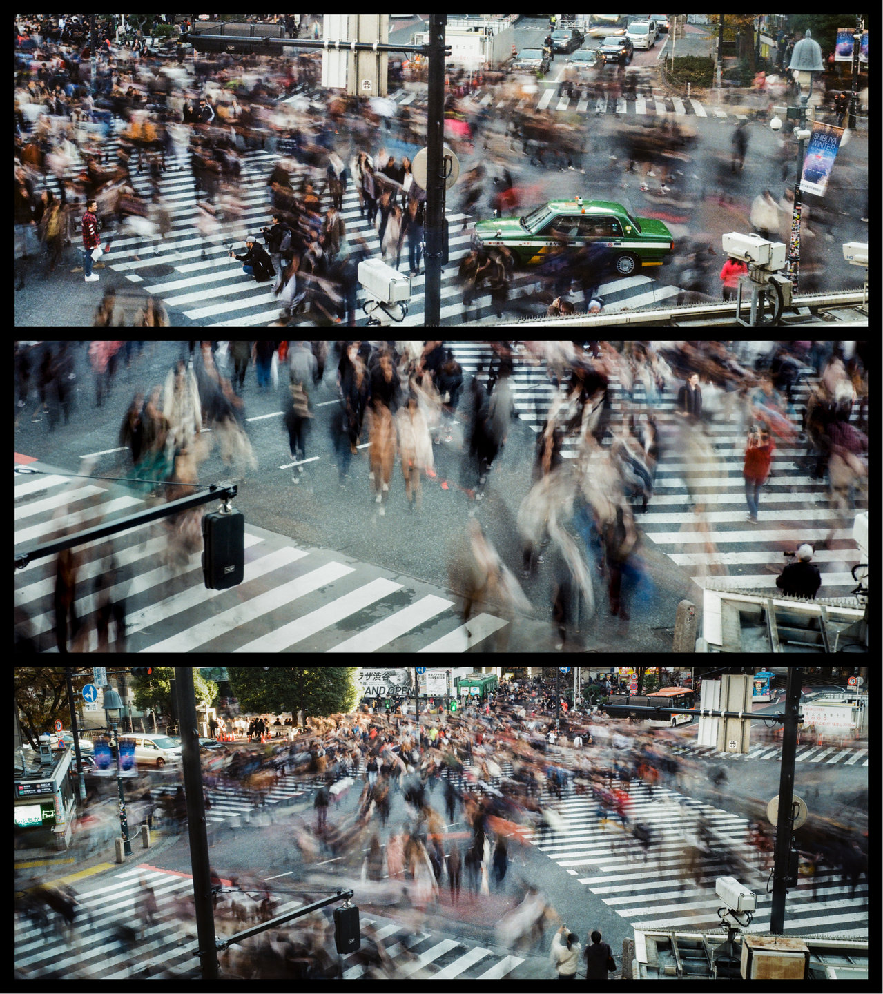 A long exposure shot captures the blurred movement of many pedestrians crossing a street at an intersection with a green taxi visible.