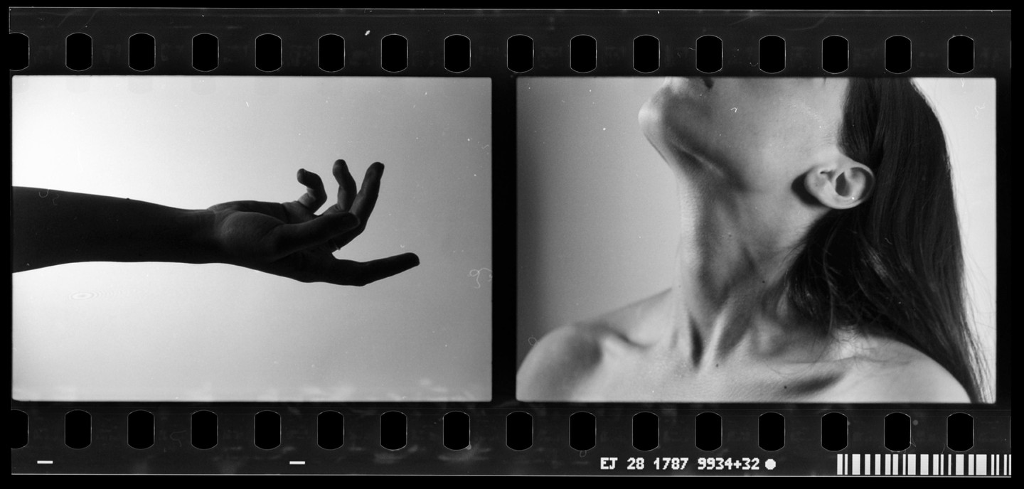 A woman's hand is on the left and her neck and shoulder are on the right.