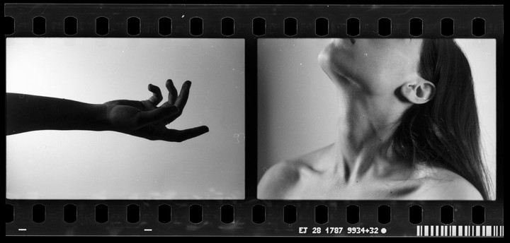 A woman's hand is on the left and her neck and shoulder are on the right.