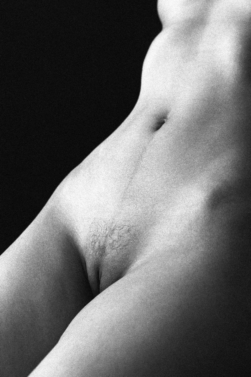 A woman's torso is visible in a black and white close-up.