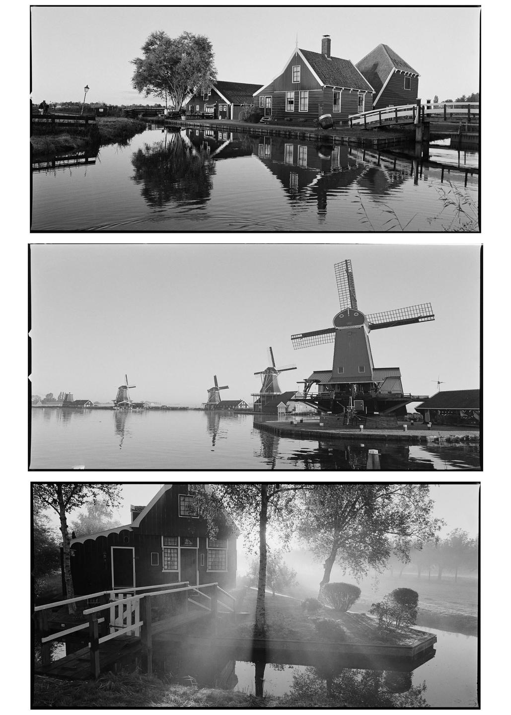 Three black and white landscape photographs show houses and windmills along a canal in Zaandam, Netherlands.