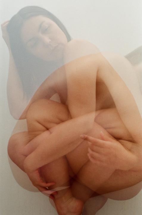 A woman is shown in a self-portrait with multiple exposures, creating a tangled effect of her body.