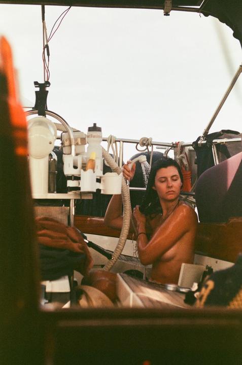 A woman showers on a boat.