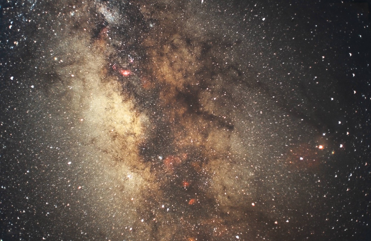 The Milky Way galaxy is visible with countless stars and cosmic dust clouds.