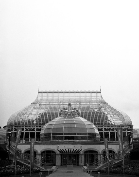 A large glass conservatory with a domed entrance is seen from the front.