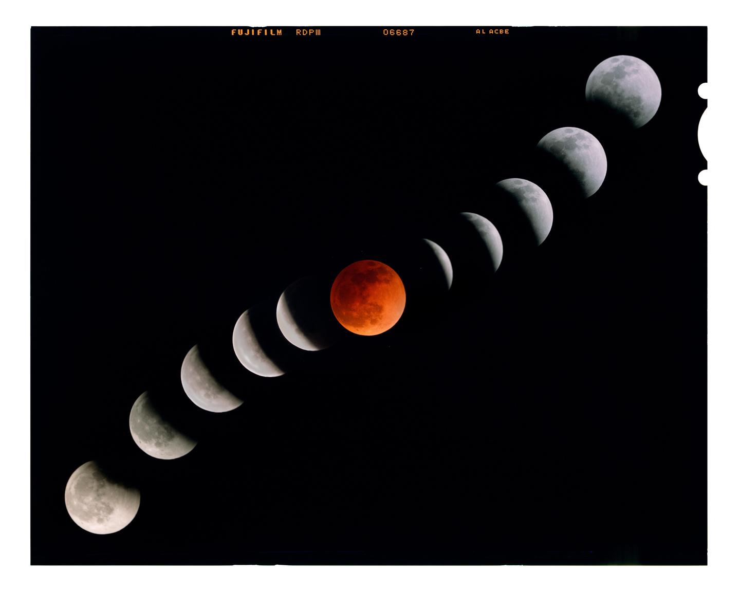 A sequence of moons in various phases of an eclipse is arranged diagonally against a black sky, with one moon appearing red.
