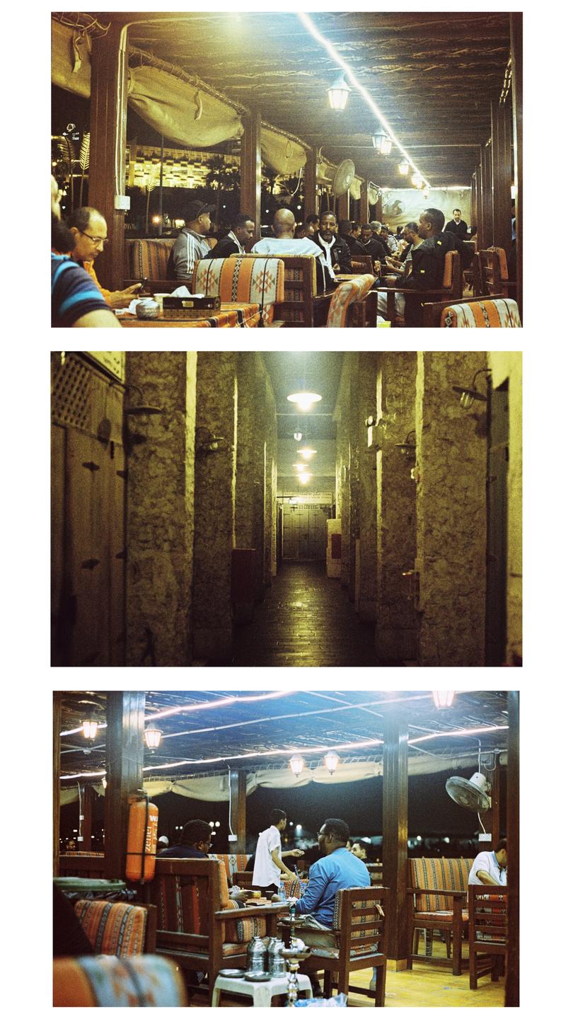 Three images show people sitting at tables in a restaurant at night, and a long, narrow hallway with stone walls and lights on the ceiling.