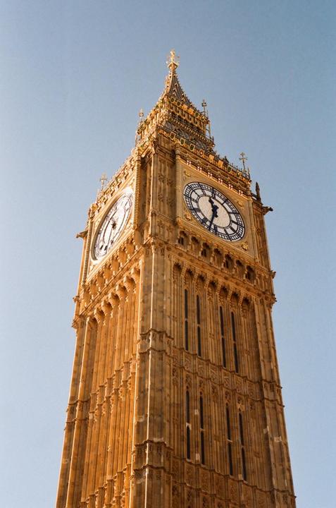 The Big Ben clock tower stands tall against a clear blue sky.