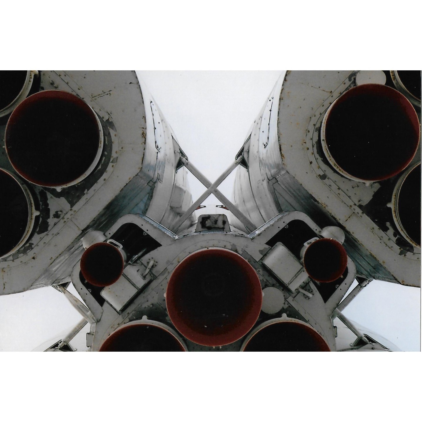 The bottom of a rocket with multiple engines is shown from below.